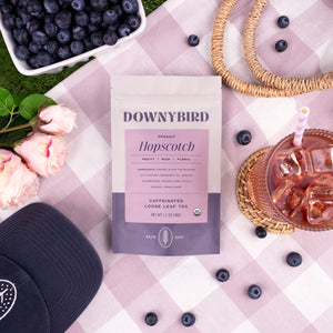 Downybird Hopscotch Blend Organic Earl Grey Loose Leaf Tea Pouch on Picnic Blanket with Blueberries